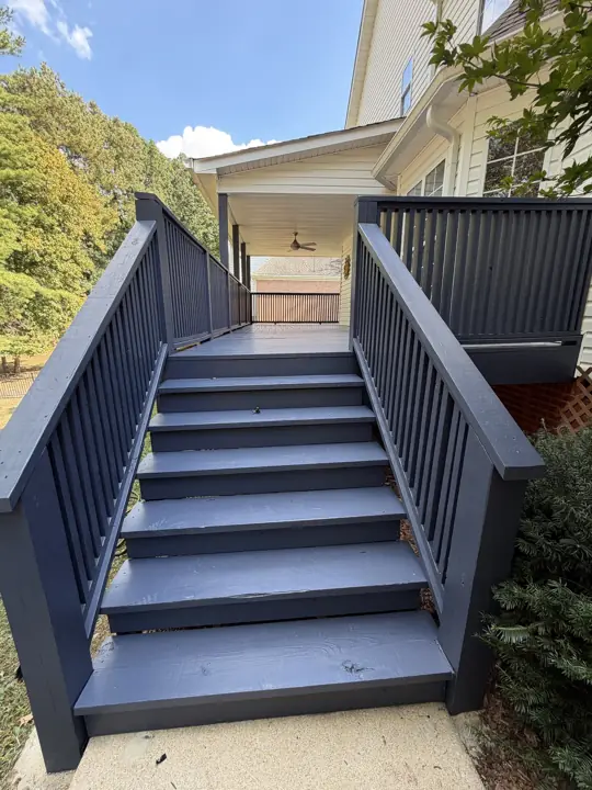 Front view of charcoal-gray stained deck stairs and handrails in Hixson, TN