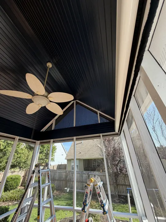 Screened porch with navy vaulted ceiling and ceiling fan after exterior painting in Ooltewah, TN
