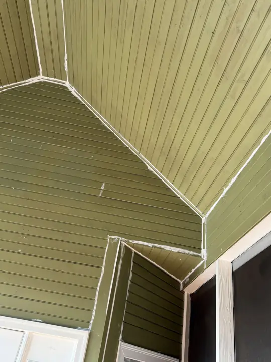 Beadboard porch ceiling seams caulked before painting in Ooltewah, TN
