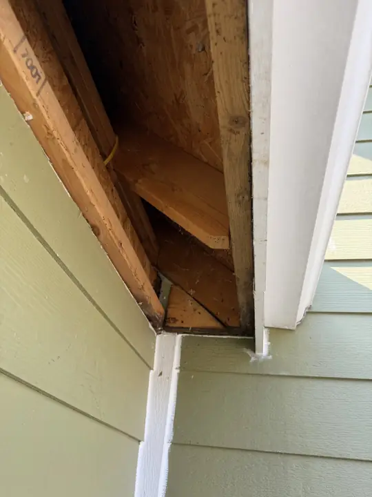 Open soffit with rotted wood removed for repair before exterior painting in Ooltewah, TN