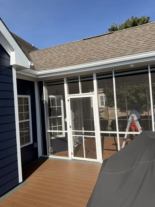Screened porch with white frame and trim next to navy siding in Ooltewah, TN