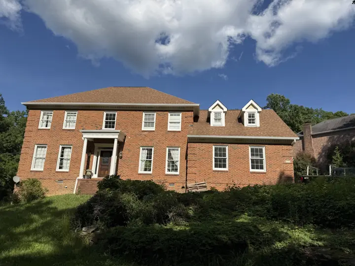 Brick colonial front with white window trim, columns and dormers in Signal Mountain, TN