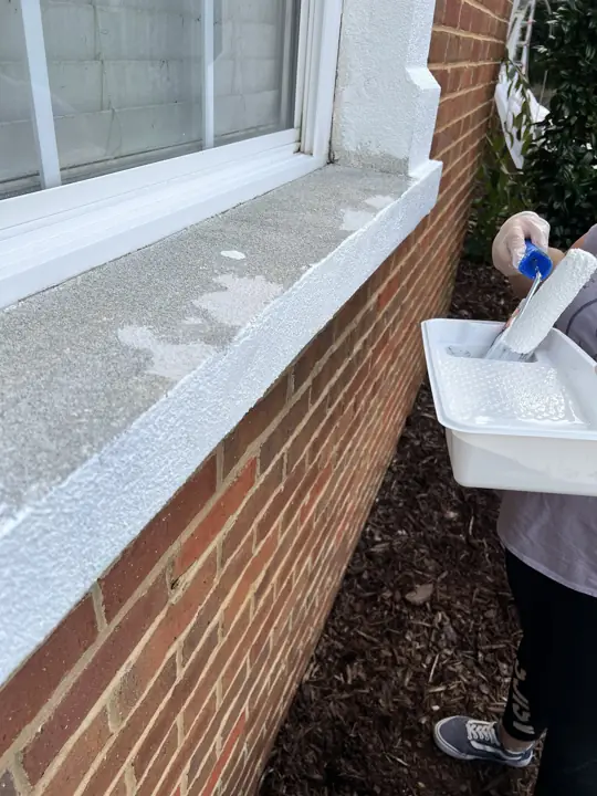 Window sill being rolled white with a roller and tray in Ooltewah, TN