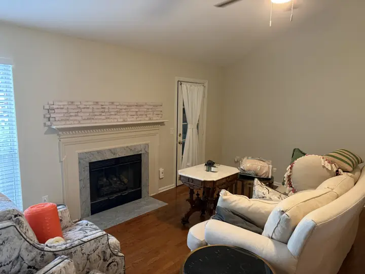 Living room with warm light walls and a white fireplace mantel, Apison, TN