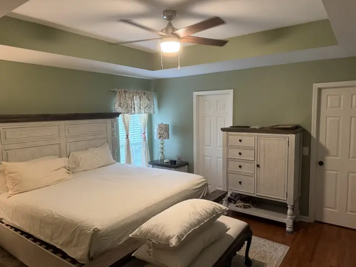 Sage green primary bedroom with green tray ceiling band and white ceiling, Apison, TN