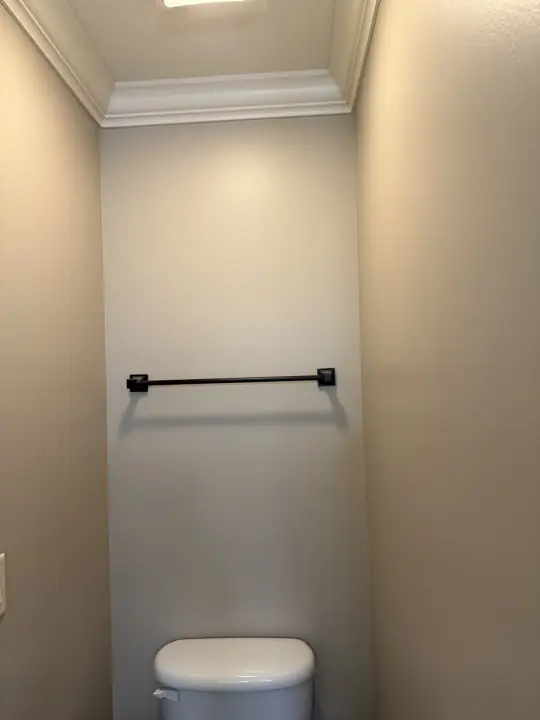 Toilet room with greige walls and white crown molding under a recessed ceiling in Hixson, TN