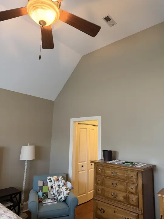 Vaulted bedroom with greige walls, white ceiling and white closet door casing in Hixson, TN