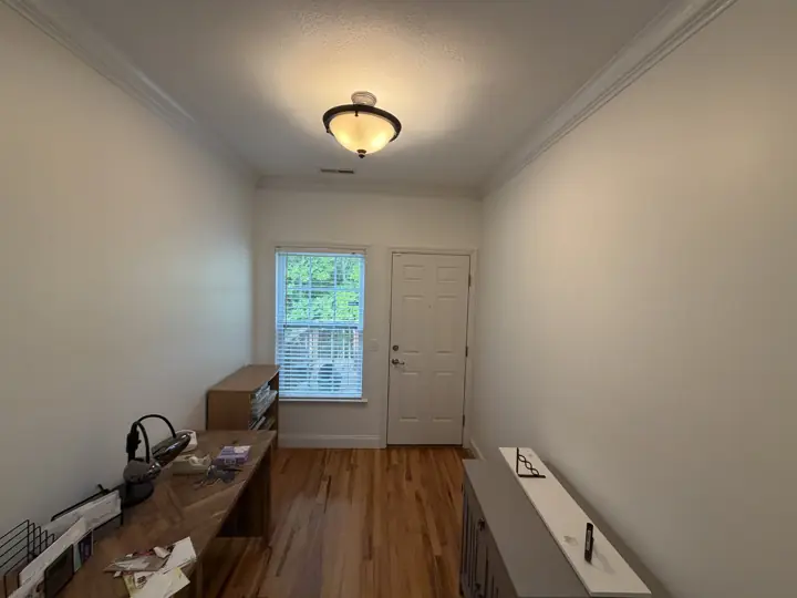 Long entry hallway with soft cream walls and white crown molding, Chattanooga, TN