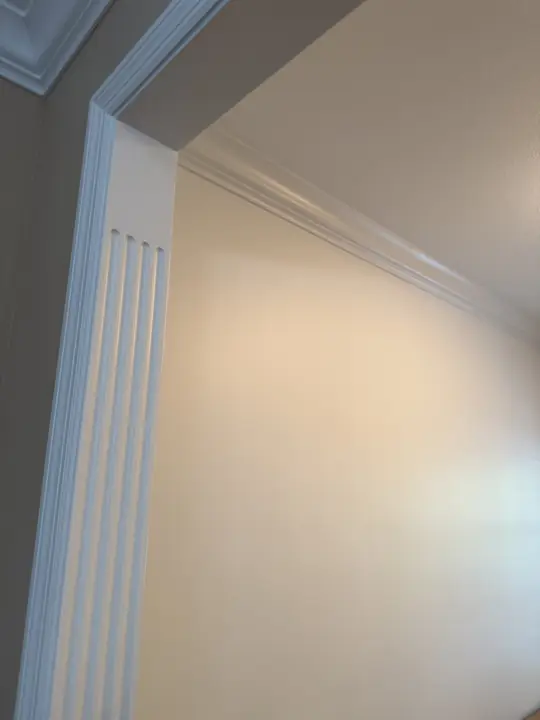 Fluted white door casing and crown molding against a pale cream wall, Chattanooga, TN
