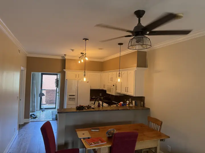 Condo kitchen and dining area with warm tan walls and white crown molding, Chattanooga, TN