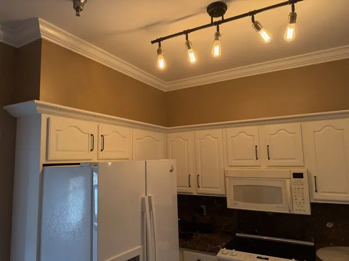 Warm tan kitchen walls above white cabinets with white crown molding, Chattanooga, TN