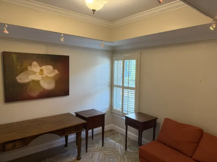 Condo living room with cream walls, white soffit crown molding and plantation shutters, Chattanooga, TN