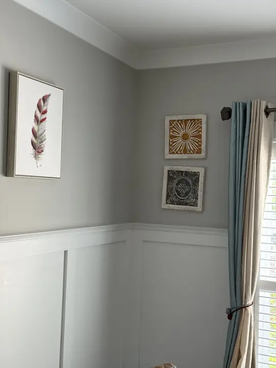 Corner of gray dining room with white wainscoting and crown molding in Ooltewah, TN