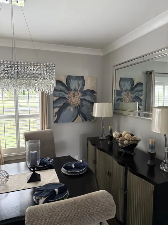 Gray dining room wall with large floral canvas and mirrored sideboard in Ooltewah, TN