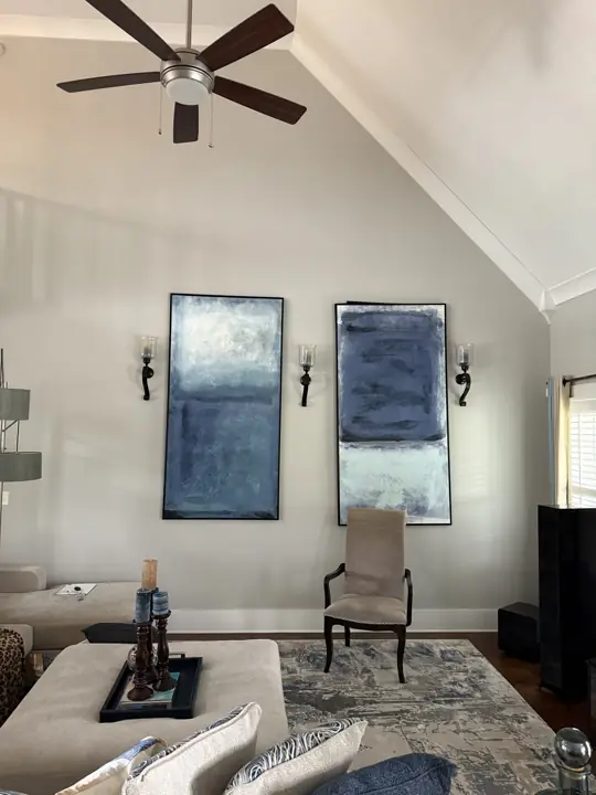 Vaulted living room with soft gray walls and white trim along the ceiling slope in Ooltewah, TN
