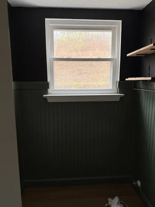 Small room with dark green beadboard wainscoting and black upper walls in Hixson, TN