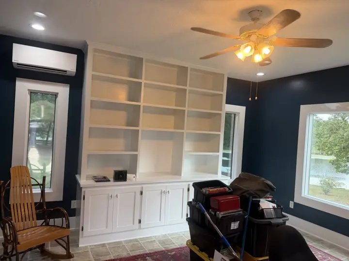 Navy blue room with white built-in shelves and white window trim overlooking a lake in Coalmont, TN
