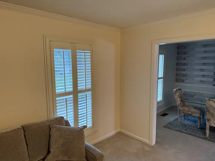 Cream living room walls with white shutters, crown molding and doorway casing in Harrison, TN