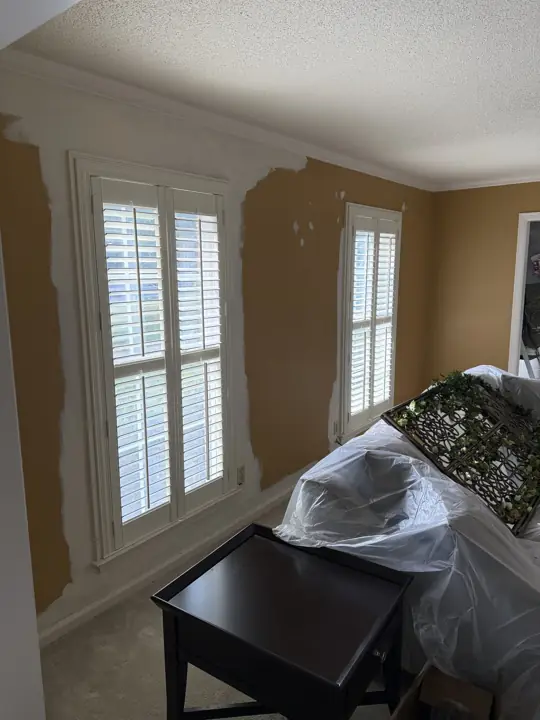 First coat cut in over old mustard gold walls around plantation shutters in Harrison, TN