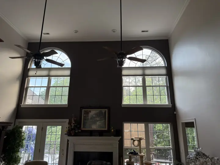 Charcoal-brown accent wall with arched windows and white crown molding in Hixson, TN