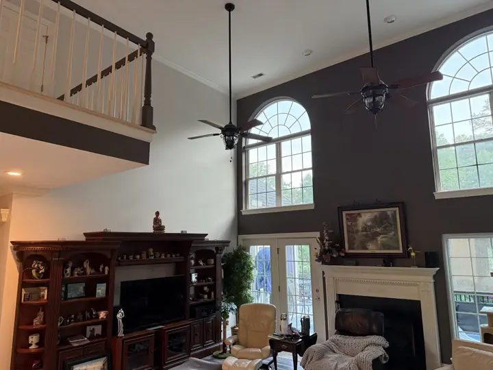 Vaulted living room with dark accent wall and loft balcony with gray fascia in Hixson, TN