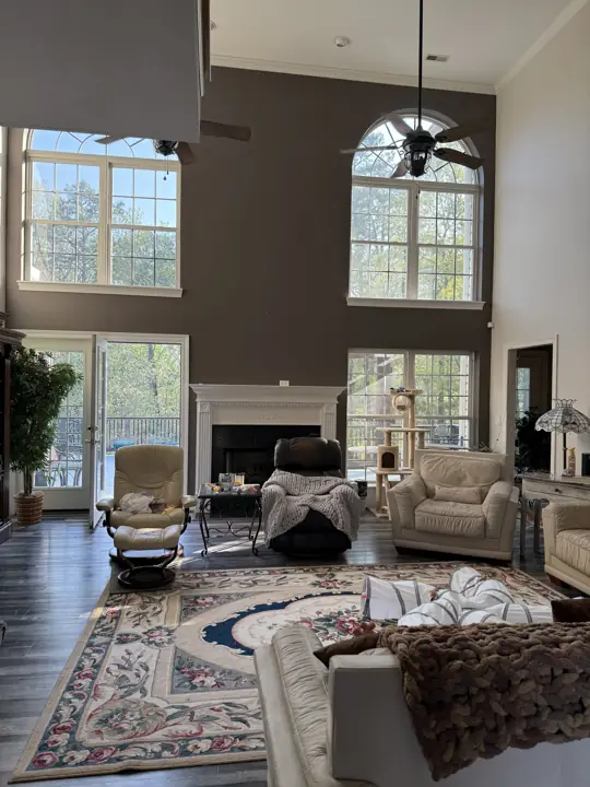 Tall living room with dark brown-gray fireplace wall and light gray side walls in Hixson, TN