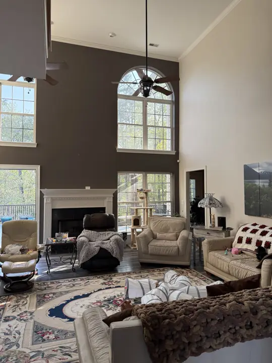 Living room with charcoal accent wall, crown molding and warm gray walls in Hixson, TN