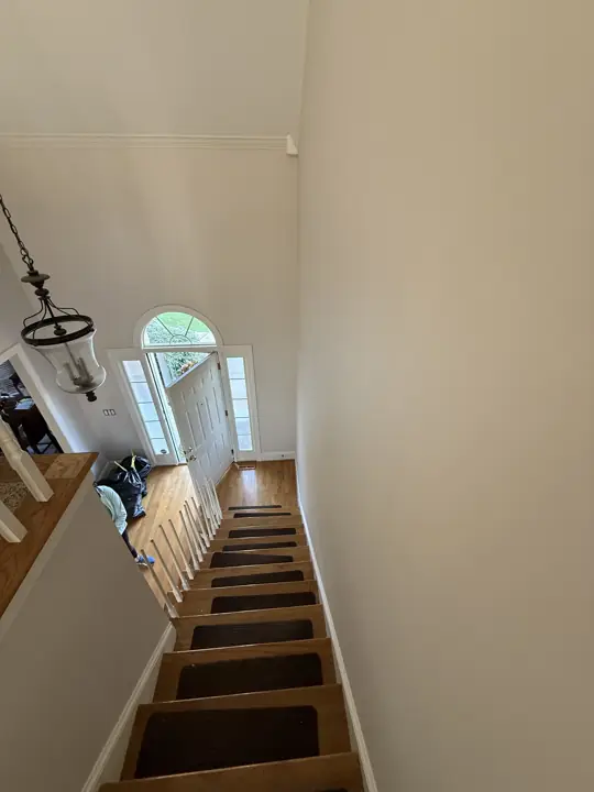 Two-story foyer with light walls seen from the top of the stairs in Hixson, TN