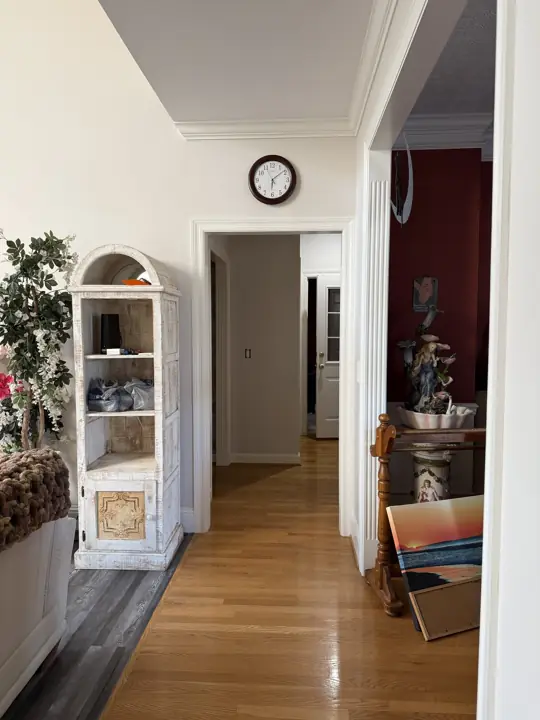 Hallway with white walls, crown molding and doorway trim in Hixson, TN