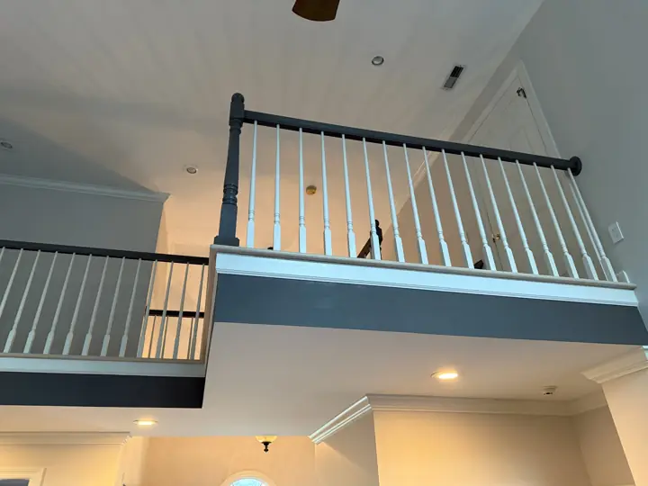 Loft balcony with slate-gray fascia band and gray handrail in Hixson, TN