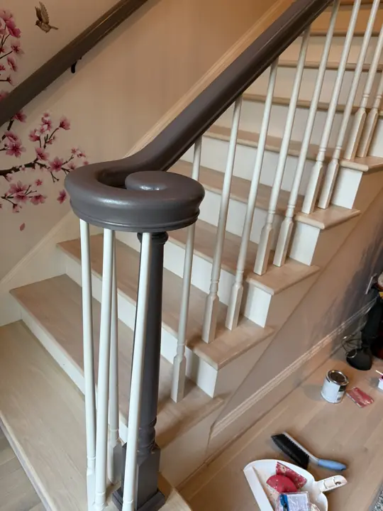Staircase with pewter handrail, white balusters and wall rail in Hixson, TN