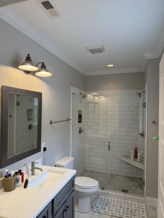 Gray bathroom with white crown molding, vanity and glass shower in Chattanooga, TN