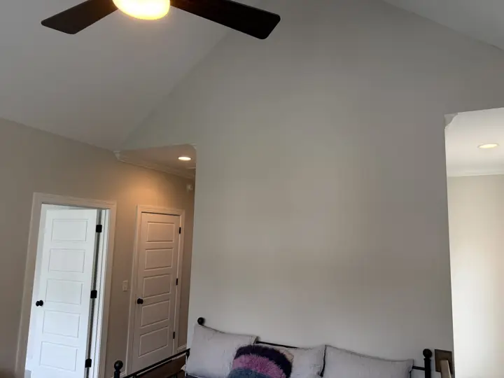 Vaulted room with pale walls rising to a white ceiling and white five-panel doors in Chattanooga, TN