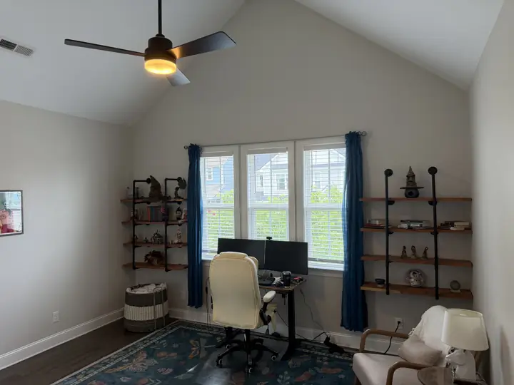 Vaulted home office with pale walls, white sloped ceiling and white window trim in Chattanooga, TN