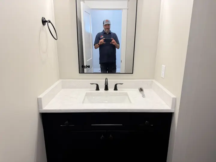 Bathroom vanity wall in warm greige with black-framed mirror, Soddy-Daisy, TN