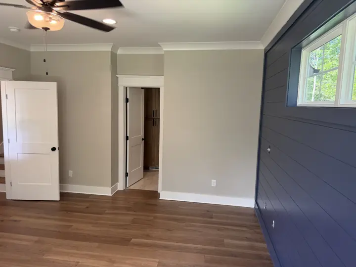 Bedroom with greige walls, white doors and trim beside a navy shiplap wall, Soddy-Daisy, TN