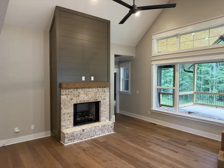 Olive green shiplap fireplace surround and vaulted greige living room after interior painting, Soddy-Daisy, TN