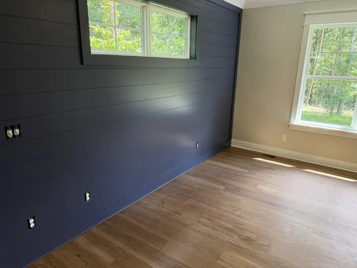 Navy shiplap wall and greige side wall with white baseboards in a bedroom, Soddy-Daisy, TN