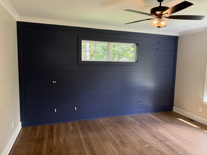 Deep navy shiplap accent wall with framed window and white crown molding in a bedroom, Soddy-Daisy, TN