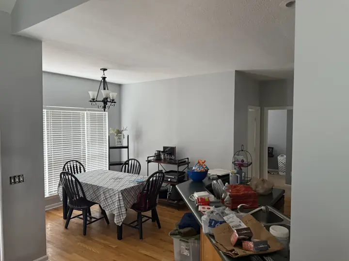 Open dining area with light gray walls and white ceiling beside the kitchen in Ooltewah, TN