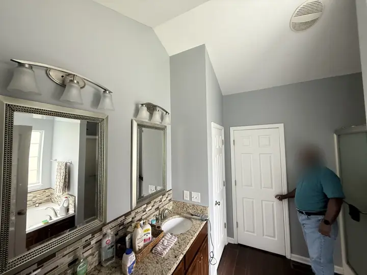 Primary bathroom vanity wall and white doors with pale blue-gray paint in Ooltewah, TN