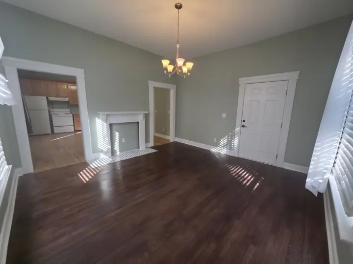 Sage green dining room with white mantel, door and trim after interior painting in Chattanooga, TN
