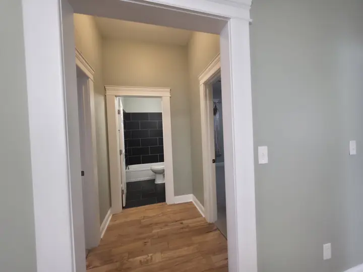 Short hallway with white door casings leading to bathroom after interior painting in Chattanooga, TN