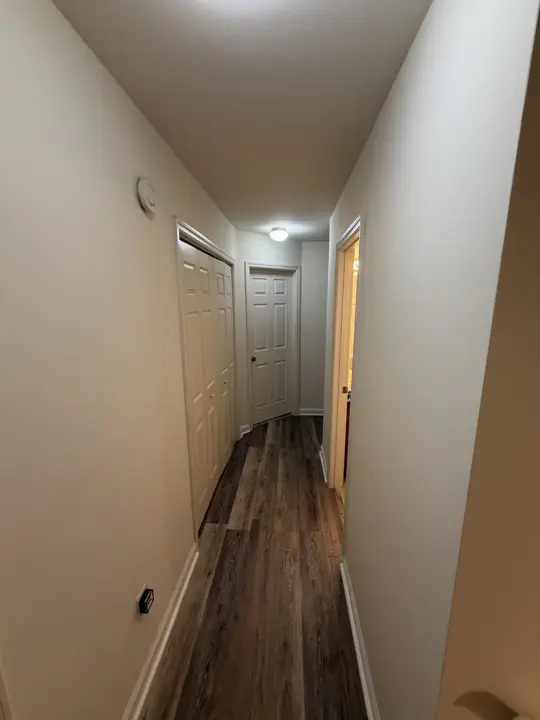 Narrow hallway with warm white walls and white six-panel doors, Chattanooga, TN