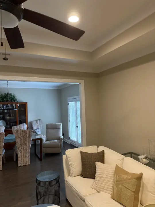 Tray ceiling and beige living room walls with view into the dining room in Chattanooga, TN