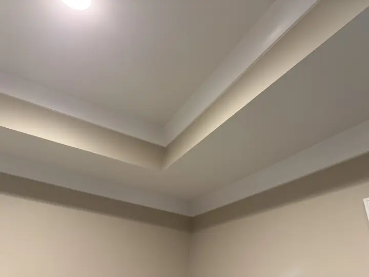 Stepped tray ceiling with white crown molding above warm beige walls after interior painting in Chattanooga, TN