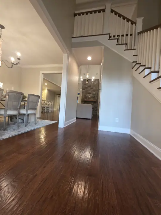 Foyer with white staircase, baseboards and cased dining room opening in Cleveland, TN