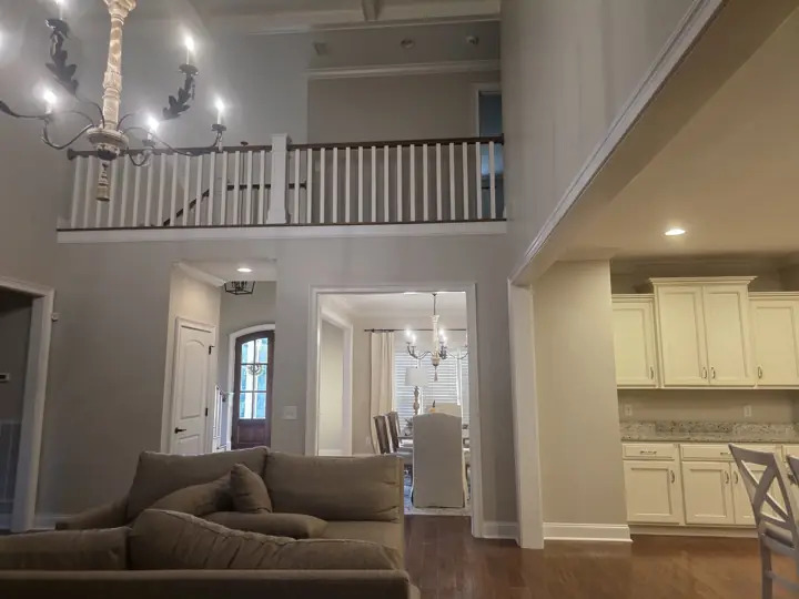 Tall living room walls in greige with white balcony railing and trim in Cleveland, TN
