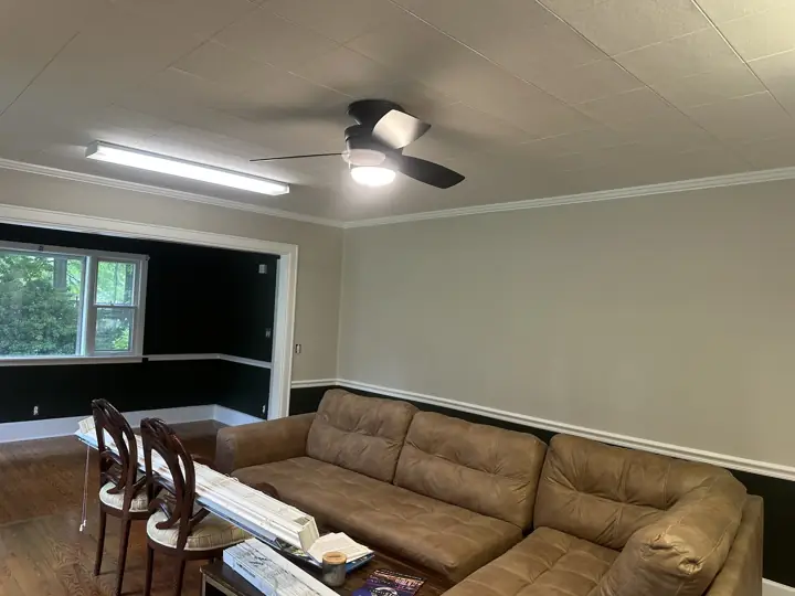 Greige wall above near-black lower wall with white chair rail and crown molding in Ringgold, GA