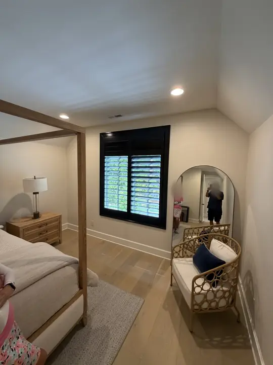 Sloped bedroom ceiling and warm white walls with white baseboards in Chattanooga, TN